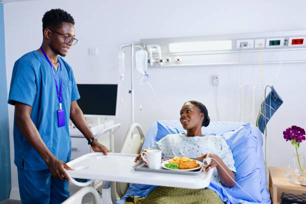 istock Caring nurse bringing lunch to a patient 2167869025