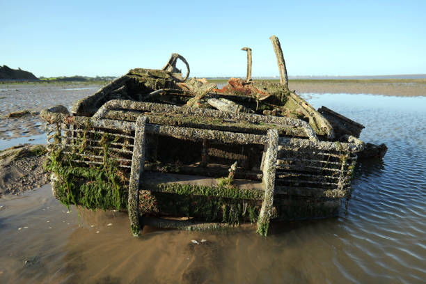 istock Close up of abandoned 4x4 sunk into sand on beach. 2167869105