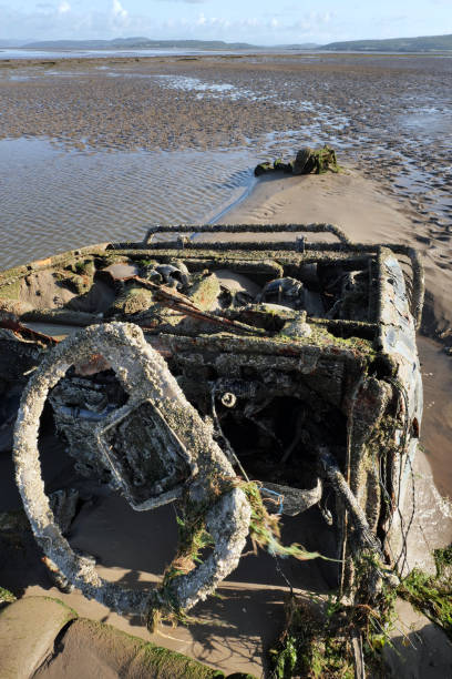istock Steering Wheel of abandoned 4x4 sunk into sand on beach. 2167869107