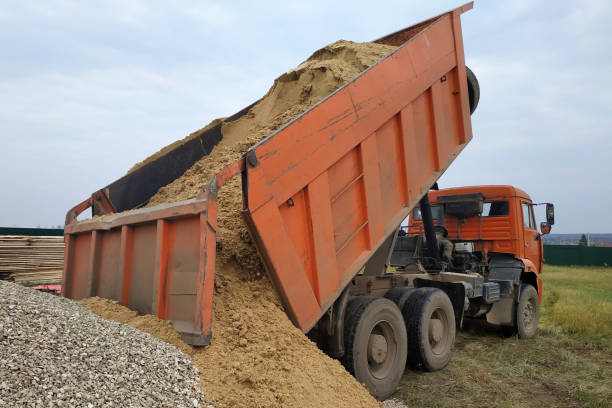 istock A dump truck unloads sand at a construction site. 2167869459