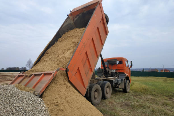 istock A dump truck unloads sand at a construction site. 2167869471