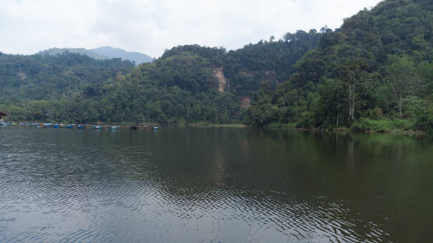 istock Small lake between hills and green forest 2167870944