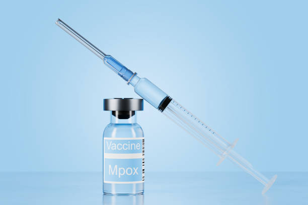 istock A clear glass bottle with the words Monkeypox Vaccine written underneath, indicating the vaccine against monkeypox. Next to the bottle is a medical syringe with the needle pointing upwards. 3d render 2167872098