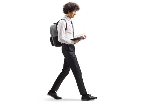 istock College student reading a book and walking 2167876852