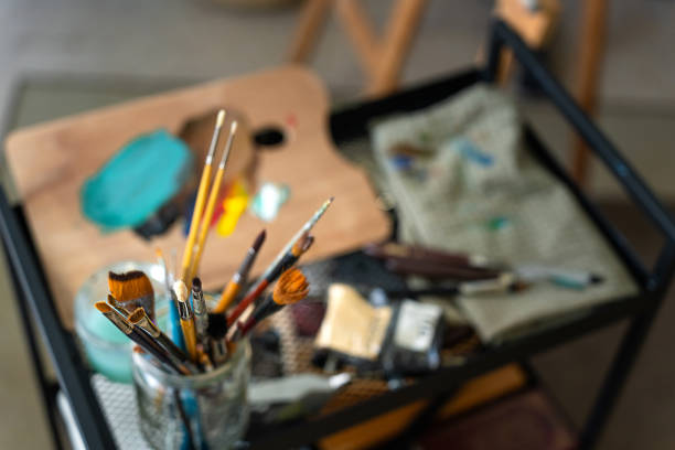 Professional painting workshop. Brushes and colours ready to work.