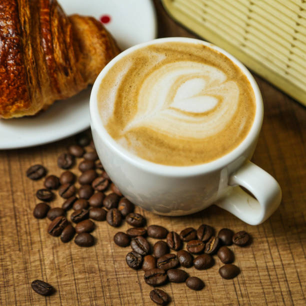 istock Coffee and Croissant on a Wooden Table 2167879811
