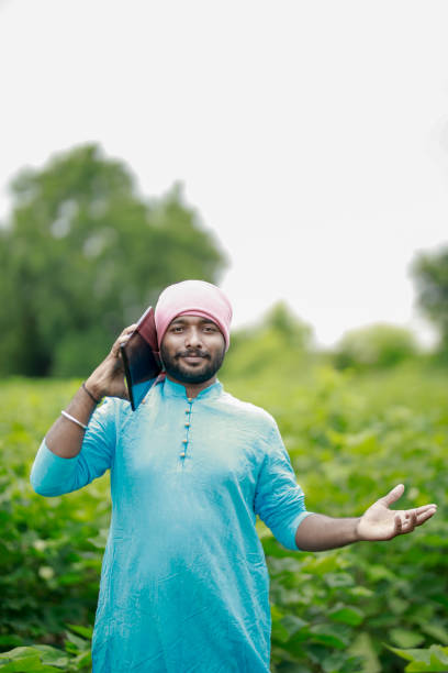istock happy young Indian farmer using smart phone 2167881642