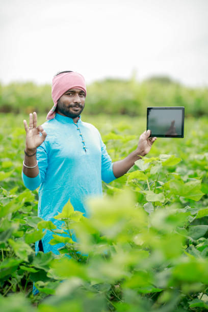 istock happy young Indian farmer using smart phone 2167883178