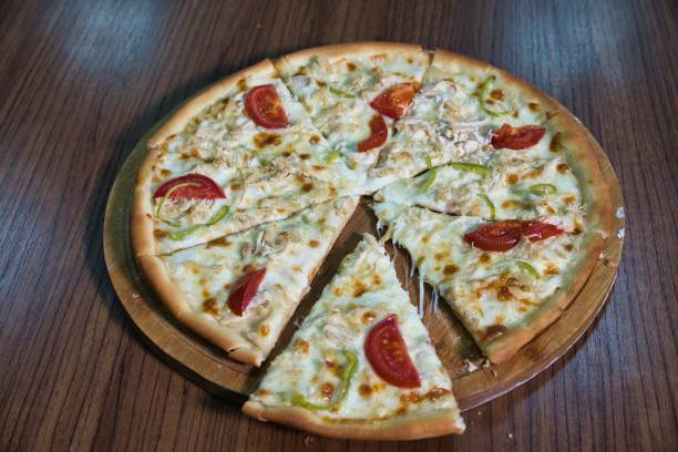 istock Sliced Chicken and Pepper Pizza on Wooden Board 2167885667