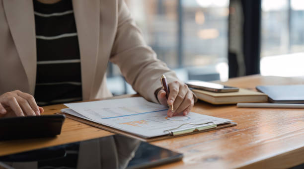 istock Businessman Analyzing Company Stock Charts and Taking Notes in a Modern Office Setting for Financial Planning 2167885963