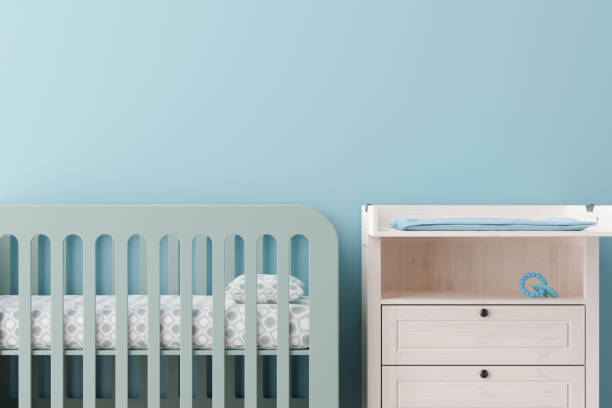 istock Serene and spacious nursery featuring a soft blue wall, complete with a mint green crib and a matching dresser with a changing pad. Copy space on the wall. Baby room interior. 3D render. 2167886398