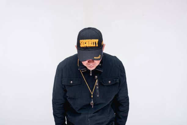 istock A security guard looking down feeling depressed and disappointed in himself. Isolated on a white background. 2167886501