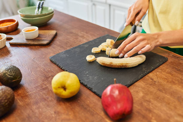 istock Young woman prepares a fruit smoothie in a bright kitchen with fresh ingredients 2167887304