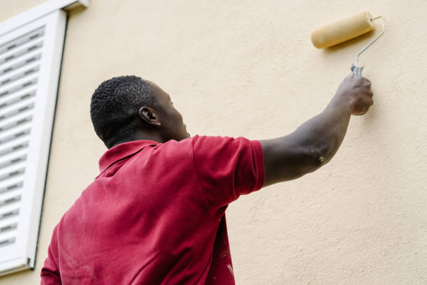 istock House painter working hard at painting a facade. 2167888650