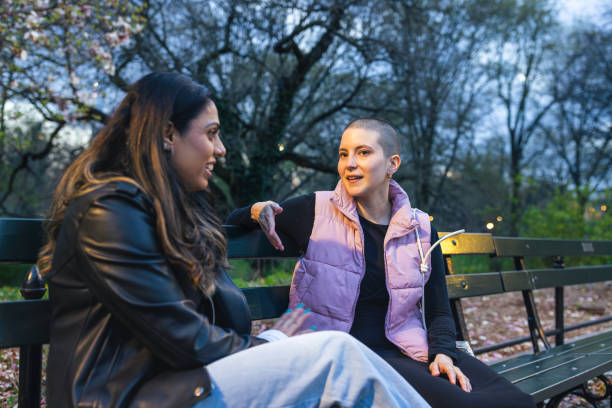 istock Friends Chatting on Park Bench at Dusk 2167888884