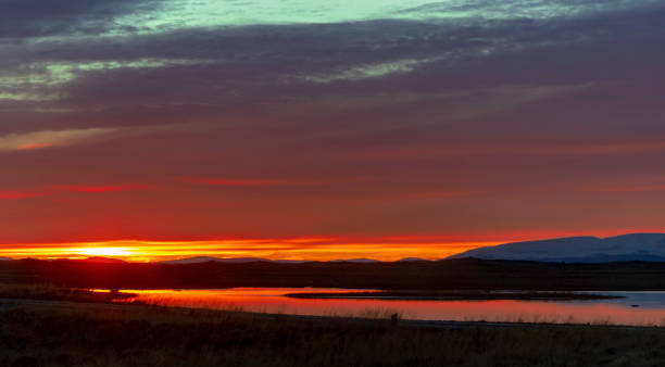 istock A beautiful sunset over a lake with mountains in the background 2167889054