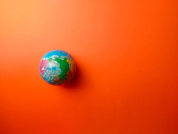 istock Top view earth globe on a orange background 2167889530
