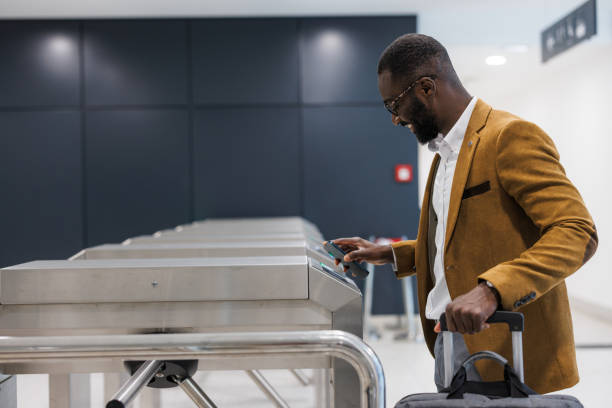istock Businessman using a smartphone for subway access at station turnstile 2167894331