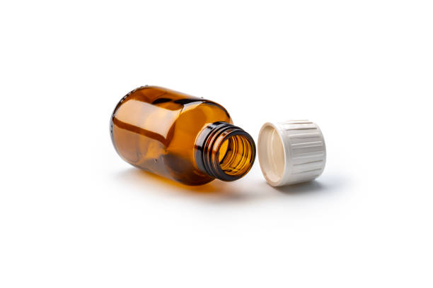 Empty brown glass medical bottle with  cap. Close up studio shot, isolated on white background. Studio shot.