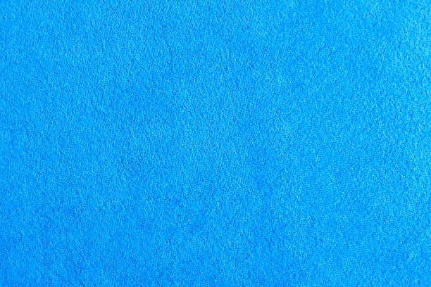 Horizontal studio shot of blue crushed velvet fabric background, slightly defocussed.