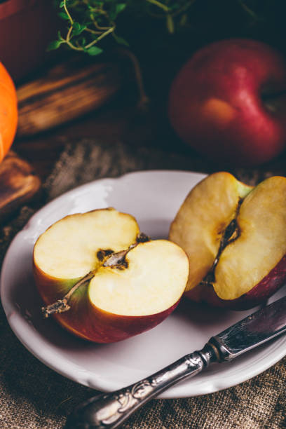 Two Halves of Red Apple on White Plate