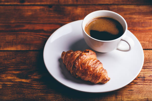 istock Cup of Black Coffee and Fresh Croissant 2167897576