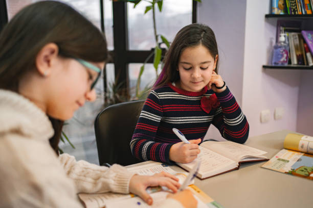 istock Two schoolgirls learning together at language school class 2167899921