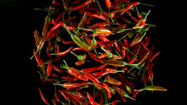 istock Red chili peppers pieces flying 2167900483