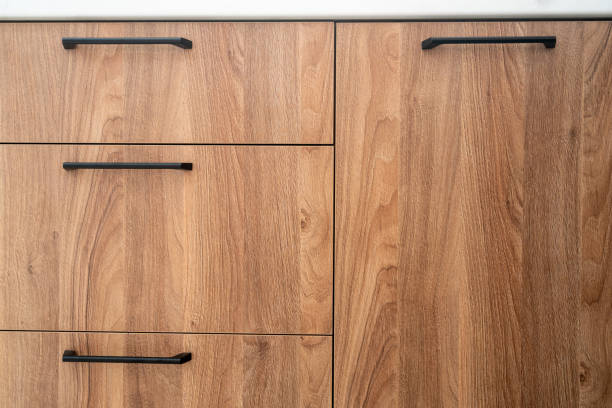 istock Wooden cabinet doors with sleek black handles in a modern kitchen setting 2167902380