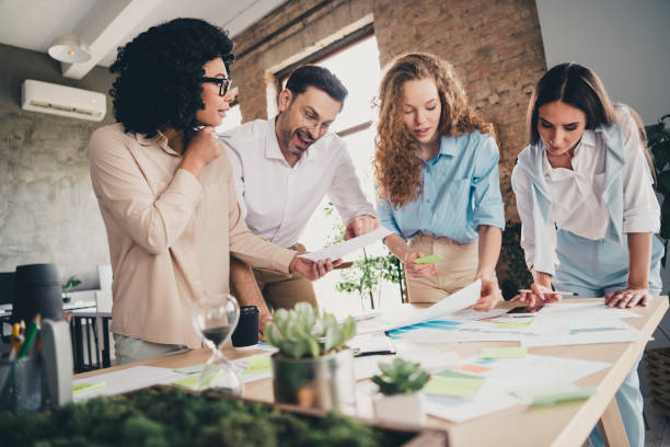 istock Photo of documents project teamwork young people working together employees modern industrial open space style interior workplace 2167903178