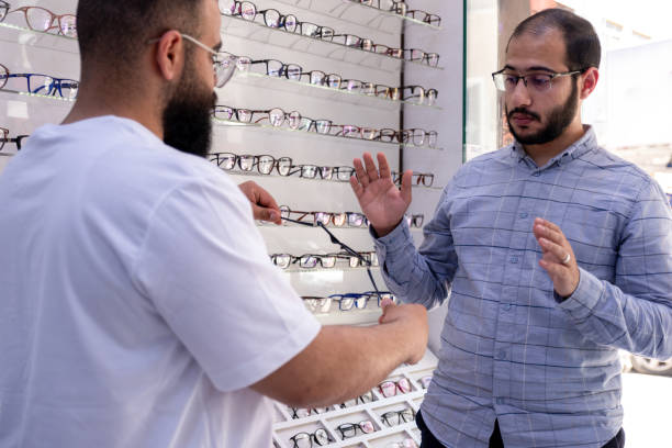 istock Male selecting the best eyeglasses, also selecting sunglasses whihc is clips eyeglasses 2167904367