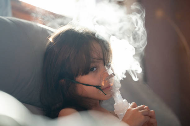 istock Sick girl kid with inhaler mask 2167904549