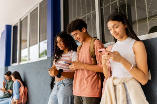 istock Teenage students using mobile phone at school 2167906534