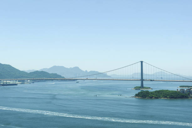 Sham Tseng, Tsuen Wan, Hong Kong- 3 August 2024: Tsing Ma Bridge with blue sea and sky