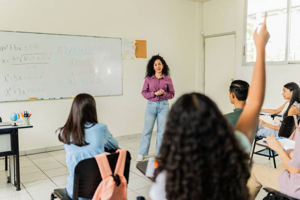 istock Mid adult teacher teaching students during class at classroom 2167907809
