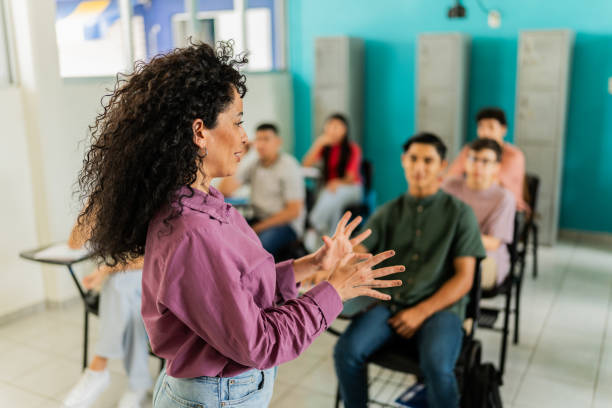 istock Mid adult teacher teaching students during class at classroom 2167907839