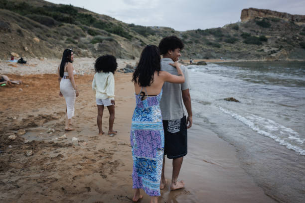 istock Group of Friends Walking at the Beach and Having Fun 2167908059