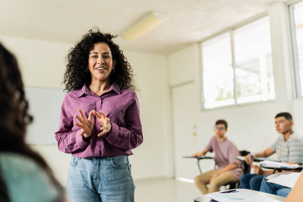 istock Mid adult teacher teaching students during class at classroom 2167908961