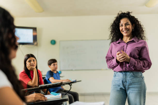 istock Mid adult teacher teaching students during class at classroom 2167908968