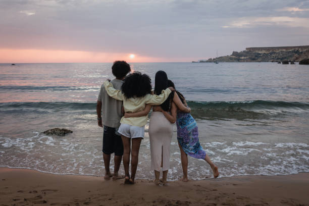 istock Young People Enjoying a Sunset at the Beach 2167909900