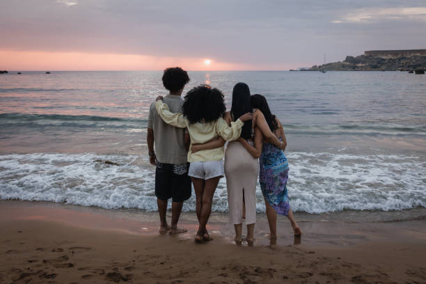 istock Best Friends Watching a Sunset at the Beach 2167909923
