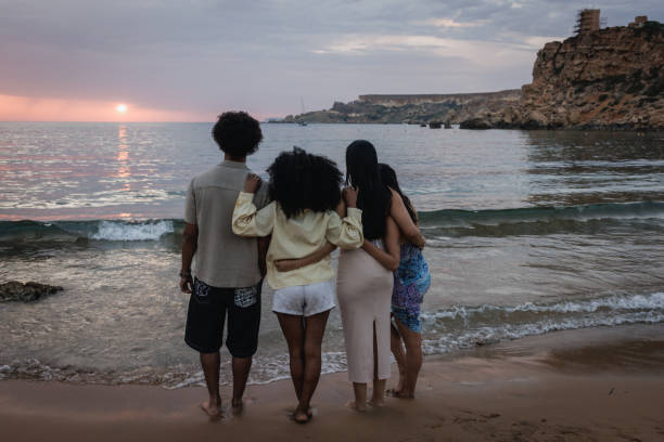 istock Diverse Group of Young People Watching a Sunset at the Beach 2167909957
