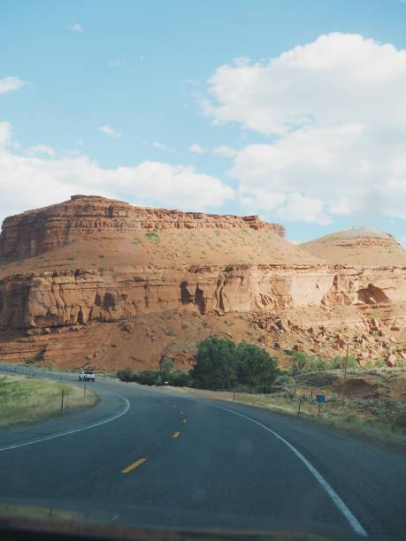 istock Road leading to red rock plateau with blue sky 2167911409