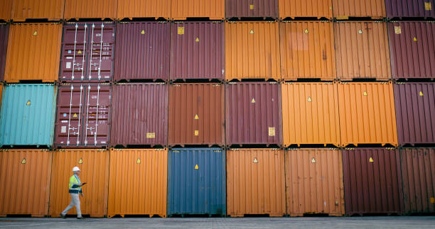 istock Container, inspection and tablet with man walking at shipping yard for logistics or supply chain. Checklist, inventory and storage on cargo background for management of delivery, export or import 2167913408