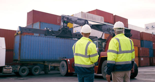istock Men, back and loader in container yard for inventory management, stock and supply chain or freight. Supervisor, inspection and quality control in industry, shipping in trade for commercial export 2167914055