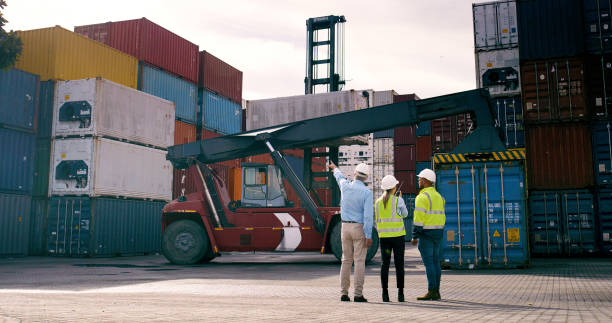 istock Container, pointing and supervisor talking to staff at commercial dock for supply chain logistics. Conversation, explain and management with team of people at harbor together for shipping from back 2167914063