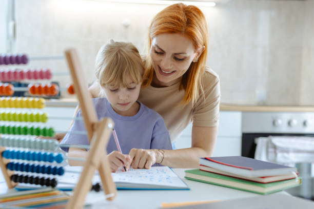 istock Mother and daughter enjoying learning together at home 2167914746