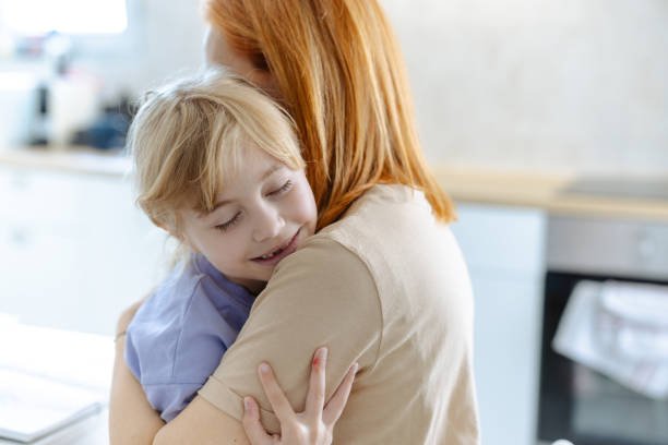 istock Loving embrace between mother and daughter in cozy kitchen setting 2167915100