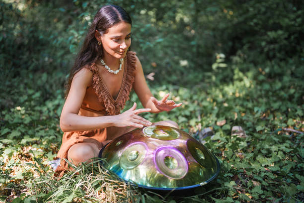 istock Environmentalist woman playing handpan in forest 2167917106