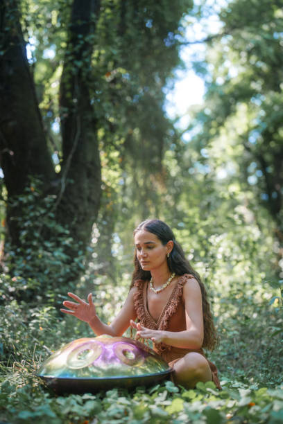 istock Environmentalist woman playing handpan in forest 2167917113